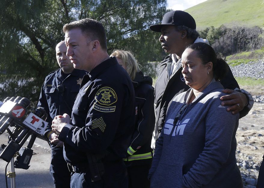 Alameda County Sheriff Sgt. Ray Kelly, left, speaks next to Ronaldo Rhodes, second from right, and Denielle Jenkins, the mother of Jayda Jenkins, right, at a news conference above Alameda Creek near Fremont, Calif., Tuesday, Jan. 24, 2017. Jayda Jenkins has been missing since Saturday, when authorities say she lost control of her car during a rainstorm and hit another car before plunging into Alameda Creek. (AP Photo/Jeff Chiu)