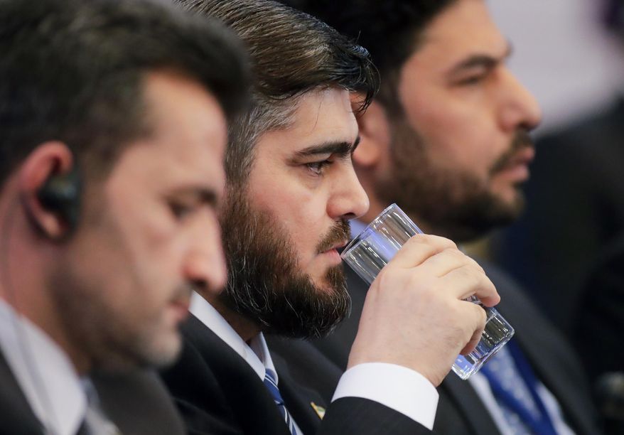 Mohammed Alloush, head of Syrian opposition delegation, drinks water during talks on Syrian peace in Astana, Kazakhstan, Monday, Jan. 23, 2017. The talks are the latest attempt to forge a political settlement to end a war that has by most estimates killed more than 400,000 people since March 2011 and displaced more than half the country's population. (AP Photo/Sergei Grits)