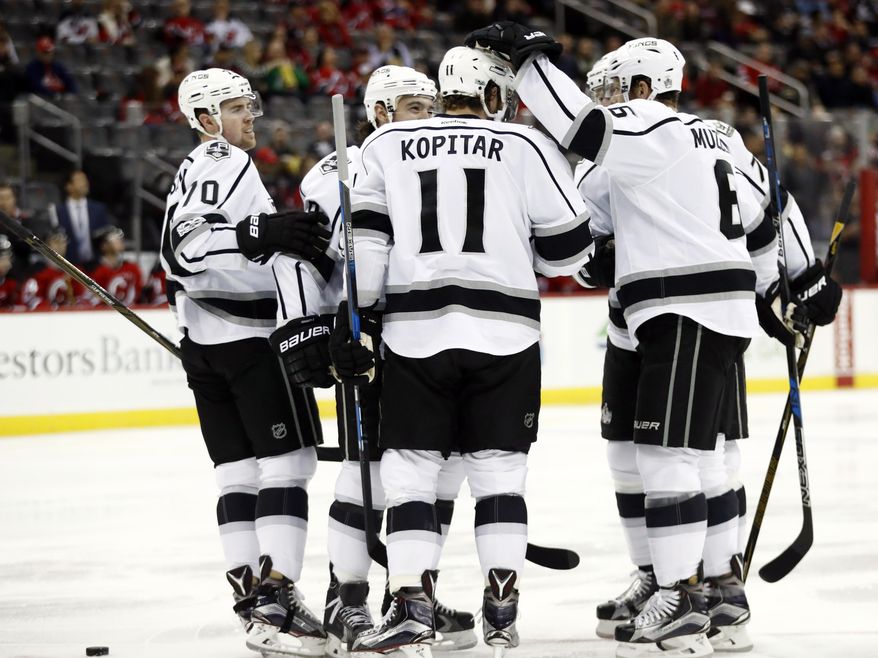 Los Angeles Kings players celebrate a goal by Anze Kopitar (11), of Slovenia, against the New Jersey Devils during the first period of an NHL hockey game, Tuesday, Jan. 24, 2017, in Newark, N.J. (AP Photo/Julio Cortez)