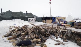 Firewood is stacked up at a protest encampment along the route of the Dakota Access oil pipeline near Cannon Ball, N.D. on Tuesday, Jan. 24, 2017. President Donald Trump on Tuesday issued an executive action to advance construction of the pipeline, which opponents believe threatens drinking water and cultural sites. The pipeline developer disputes that. (AP Photo/James MacPherson)