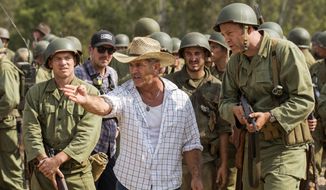 This image released by Summit shows director Mel Gibson, center, and actor Vince Vaughn on the set of the film, &amp;quot;Hacksaw Ridge.&amp;quot; Gibson was nominated for an Oscar for best directing  on Tuesday, Jan. 24, 2017, for his work on the film. The 89th Academy Awards will take place on Feb. 26. (Summit via AP)