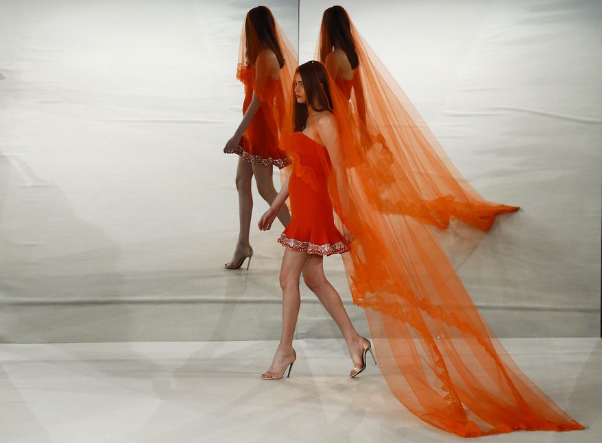 A model wears a creation by Alexis Mabille during his Haute Couture Spring-Summer 2017 fashion collection presented in Paris, Tuesday, Jan. 24, 2017. (AP Photo/Francois Mori)