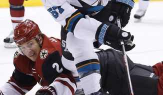 FILE - In this Nov. 1, 2016, file photo, Arizona Coyotes defenseman Luke Schenn (2) disrupts the shot attempt by San Jose Sharks center Tommy Wingels (57) during the first period of an NHL hockey game in Glendale, Ariz. The Sharks have traded Wingels to the Ottawa Senators on Tuesday, Jan. 24, 2017, for two minor league forwards and a 2017 seventh-round draft pick. (AP Photo/Ross D. Franklin, File)