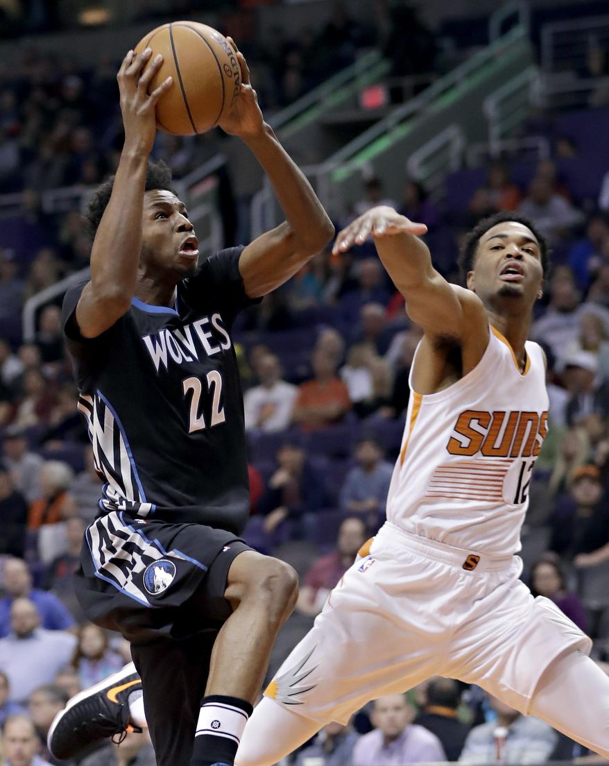 Minnesota Timberwolves forward Andrew Wiggins (22) shoots over Phoenix Suns forward TJ Warren (12) during the first half of an NBA basketball game, Tuesday, Jan. 24, 2017, in Phoenix. (AP Photo/Matt York)