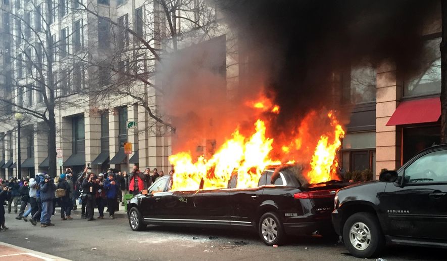 Protesters set a parked limousine on fire in downtown Washington, Friday, Jan. 20, 2017, during the inauguration of President Donald Trump. Protesters registered their rage against the new president Friday in a chaotic confrontation with police who used pepper spray and stun grenades in a melee just blocks from Donald Trump&#x27;s inaugural parade route. Scores were arrested for trashing property and attacking officers. (AP Photo/Juliet Linderman)