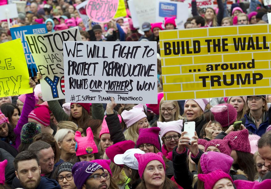 FILE - In this Saturday, Jan. 21, 2017 file photo, women with bright pink hats and signs begin to gather early and are set to make their voices heard on the first full day of Donald Trump's presidency, in Washington. The owner of a Tennessee knitting store doesn't want anyone buying its yarn for arts and crafts for the women's movement, following weekend protests by marchers in knitted, pointy-eared hats. The Tennessean newspaper reported that the comments Tuesday on the Facebook page of The Joy of Knitting store in Franklin drew both support and vows of a boycott. (AP Photo/Jose Luis Magana, File)
