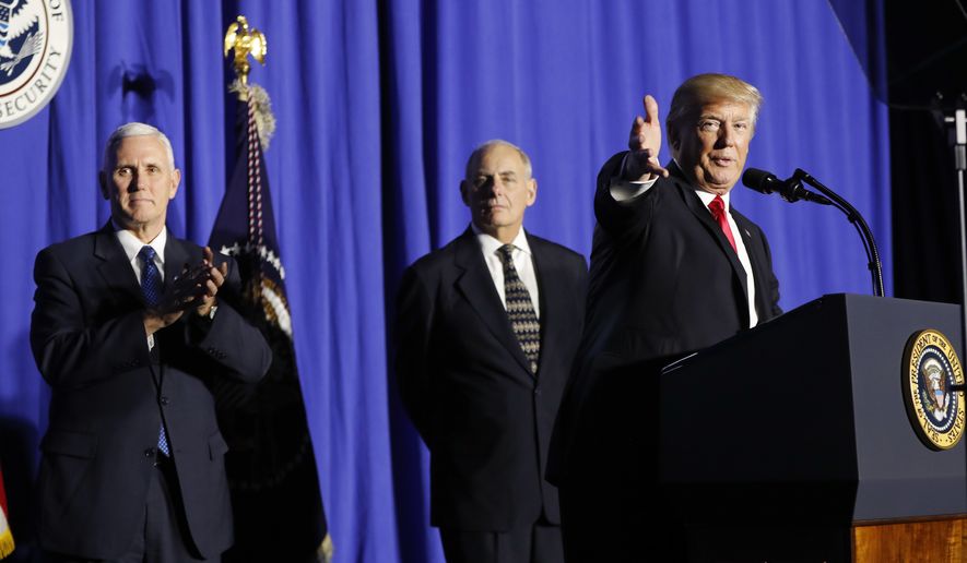 President Donald Trump, accompanied by Vice President Mike Pence and Homeland Security Secretary John F. Kelly, gestures as he speaks at the Homeland Security Department in Washington, Wednesday, Jan. 25, 2017. (AP Photo/Pablo Martinez Monsivais)
