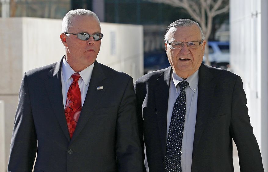 Former Maricopa County Sheriff Joe Arpaio, right, is joined by Arpaio's former Chief Deputy Jerry Sheridan, left, as they arrive at U.S. District Court for Arpaio's latest hearing in the criminal contempt-of-court case against him for violating a judge's orders in a racial profiling case Wednesday, Jan. 25, 2017, in Phoenix. (AP Photo/Ross D. Franklin)