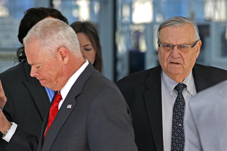 Former Maricopa County Sheriff Joe Arpaio, right, walks with his former Chief Deputy Jerry Sheridan, left, as Arpaio leaves U.S. District Court after his latest hearing in the criminal contempt-of-court case against him for violating a judge's orders in a racial profiling case Wednesday, Jan. 25, 2017, in Phoenix. (AP Photo/Ross D. Franklin)