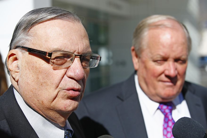 Former Maricopa County Sheriff Joe Arpaio, left, speaks to the media as his his attorney Mel McDonald, right, listens, as the two leave U.S. District Court after Arpaio's latest hearing in the criminal contempt-of-court case against him for violating a judge's orders in a racial profiling case, Wednesday, Jan. 25, 2017, in Phoenix. (AP Photo/Ross D. Franklin)