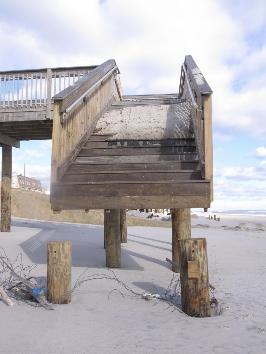 A set of stairs that used to lead to the beach now ends in mid-air in the Toms River section of Ortley Beach N.J. on Wednesday, Jan. 25, 2017, after a two-day nor'easter that caused moderate to significant beach erosion along the Jersey shore. (AP Photo/Wayne Parry)