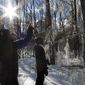 In this Sunday, Jan. 15, 2017 photo, USDA Forest Service researchers Paul Schaberg, left, and Lindsey Rustad, right, examine the aftermath of a manufactured ice storm at the Hubbard Brook Experimental Forest in Woodstock, N.H. A team of scientists sprayed water on the trees the night before as part of a study designed to examine the effects of ice on northern forests. (AP Photo/Holly Ramer)
