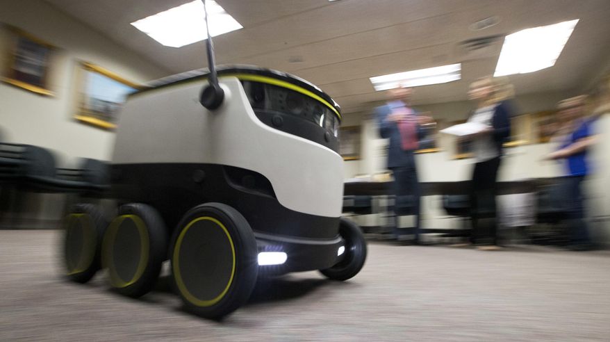 The Starship Technologies delivery robot goes through it's paces during a demonstration at the Capitol in Richmond, Va., Wednesday, Jan. 25, 2017. State lawmakers have partnered with European company Starship Technologies on bills that would allow Virginia cities to join two others in the U.S. and many across Europe where the company is testing the robots. Much like big-time retailers' attempts at drone deliveries, the robots aim to revolutionize the way people get their parcels. (AP Photo/Steve Helber)