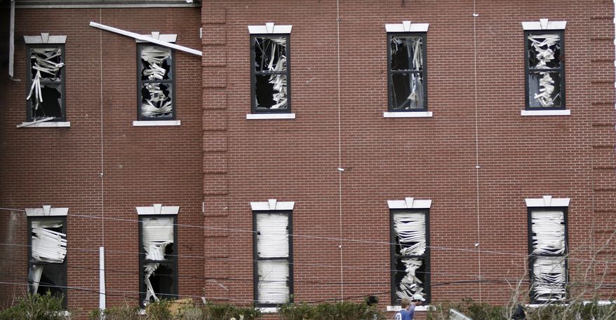FILE - This Jan. 21, 2017 file photo shows the damaged blinds in the windows of William Carey University's School of Business after a tornado touched down in Hattiesburg, Miss. The university heavily damaged by a tornado is taking more steps toward recovery. William Carey University wants students to return to campus Wednesday, Jan. 25 through Friday to retrieve personal belongings and cars. (AP Photo/Rogelio V. Solis)