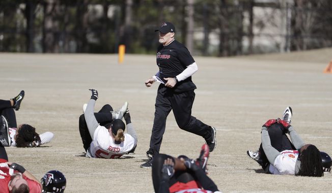 Atlanta Falcons head coach Dan Quinn runs through a workout at the football team's practice facility in Flowery Branch, Ga., Wednesday, Jan. 25, 2017. (AP Photo/David Goldman)