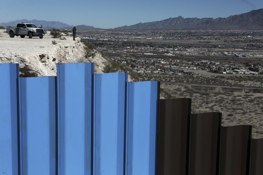 An agent of the border patrol, observes near the Mexico-US border fence, on the Mexican side, separating the towns of Anapra, Mexico and Sunland Park, New Mexico, Wednesday, Jan. 25, 2017. U.S. President Donald Trump says his administration will be working in partnership in Mexico to improve safety and economic opportunity for both countries and will have "close coordination" with Mexico to address drug smuggling. It will set in motion the construction of his proposed border wall, a key promise from his 2016 campaign. (AP Photo/Christian Torres)