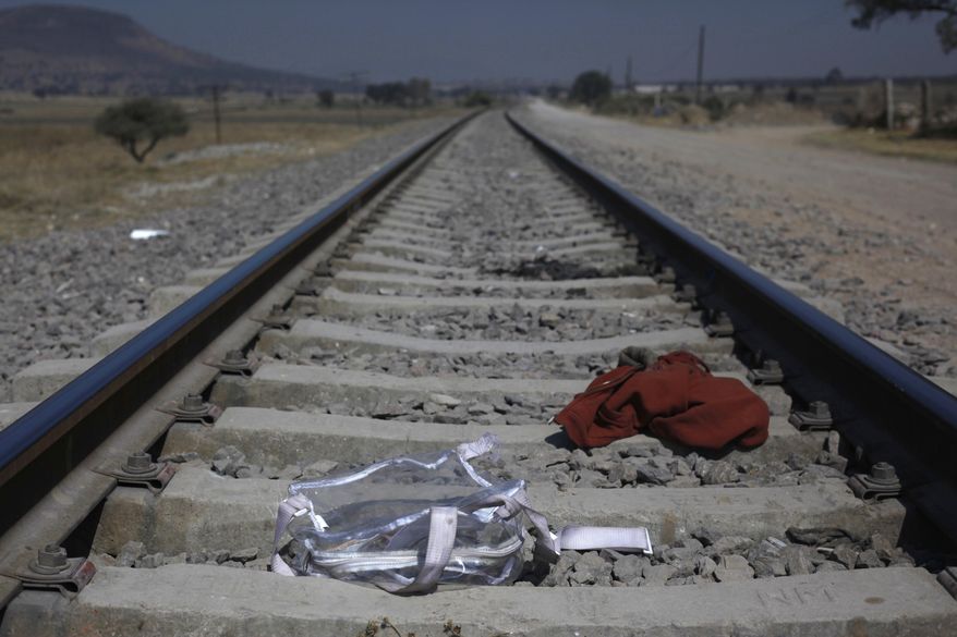 Clothing and a backpack lay on the tracks of the railroad used by migrants jumping trains traveling northbound, on the outskirts of Mexico City, Wednesday, Jan. 25, 2017. President Donald Trump moved aggressively to tighten U.S. immigration controls Wednesday, signing executive actions to jumpstart construction of a U.S.-Mexico border wall and cut federal grants for immigrant-protecting "sanctuary cities." (AP Photo/Marco Ugarte)