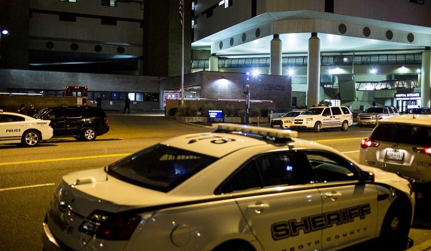 A DeSoto County Sheriff car is parked outside of the Regional Medical Center on Wednesday, Jan. 25, 2017 in Memphis, Tenn. A Mississippi sheriff says two deputies are expected to recover after they were wounded and a robbery suspect was killed during a shootout. The unidentified suspect was killed Wednesday night outside a grocery store in Southaven, just south of Memphis. (Brad Vest/The Commercial Appeal via AP)