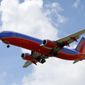 In this Friday, Aug. 26, 2016, photo, a Southwest Airlines jet makes its approach to Dallas Love Field airport, in Dallas. Southwest Airlines Co. reports financial results Thursday, Jan. 26, 2017. (AP Photo/Tony Gutierrez)