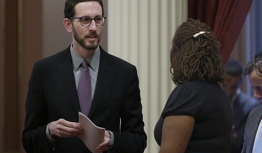 State Sen. Scott Wiener, D-San Francisco, left, talks with Sen. Holly Mitchell, D-Los Angeles, at the Capitol, Thursday, Jan. 26, 2017, in Sacramento, Calif. Wiener, and Sen. Toni Atkins, D-San Diego, introduced legislation on Thursday to add a non-binary gender option on state identifying documents including driver's licenses, birth certificates and identity cards.AP Photo/Rich Pedroncelli)