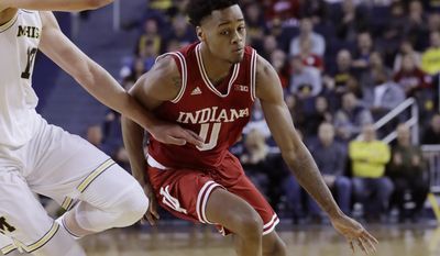 Indiana guard Curtis Jones (0) drives around Michigan forward Moritz Wagner during the first half of an NCAA college basketball game, Thursday, Jan. 26, 2017, in Ann Arbor, Mich. (AP Photo/Carlos Osorio)