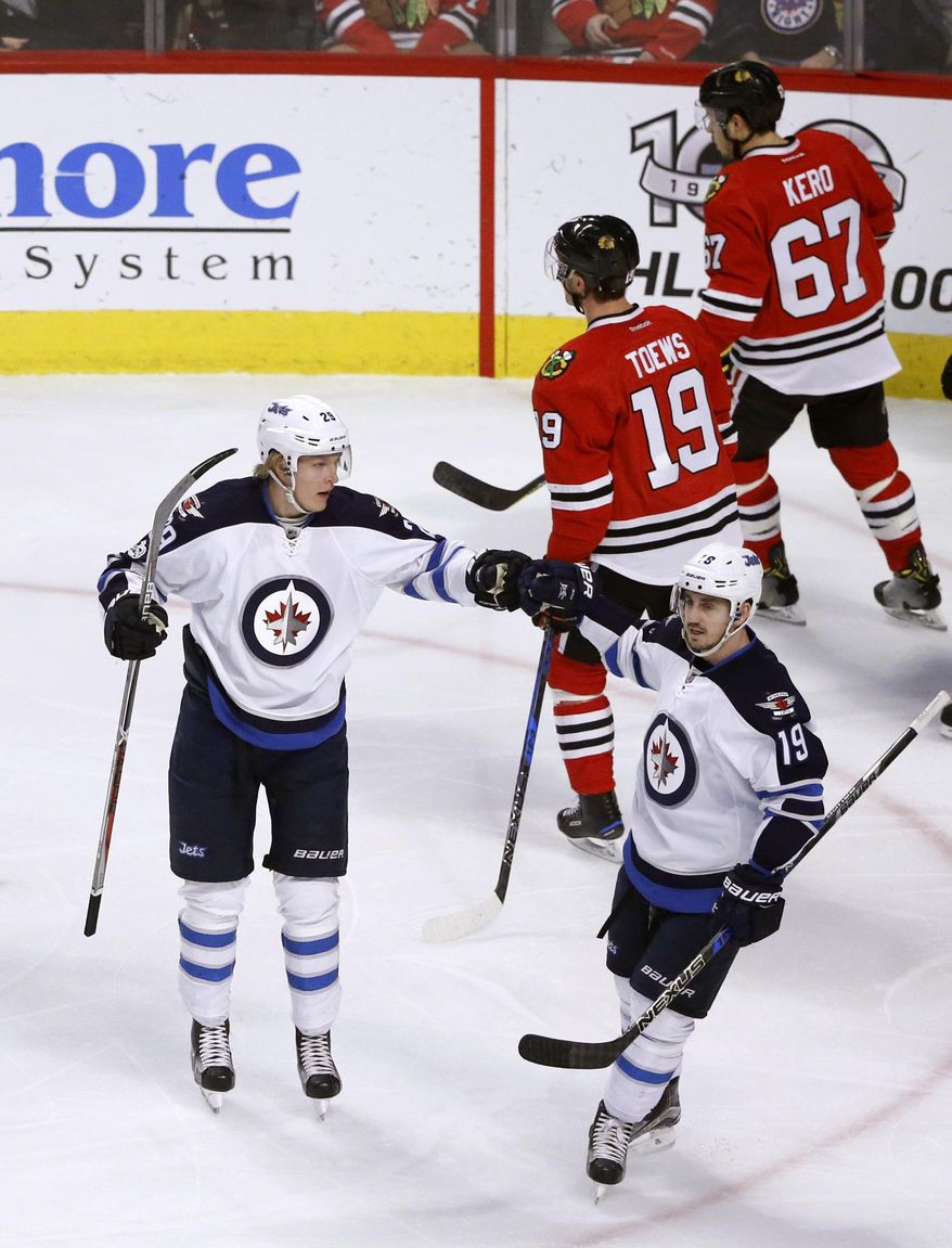 Winnipeg Jets' Patrik Laine, left, celebrates his goal with Nic Petan during the first period of an NHL hockey game against the Chicago Blackhawks Thursday, Jan. 26, 2017, in Chicago. (AP Photo/Charles Rex Arbogast)