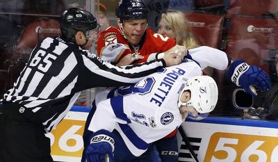 Florida Panthers left wing Shawn Thornton (22) and Tampa Bay Lightning center Cedric Paquette (13) fight as linesman Pierre Racicot intervenes during the second period of an NHL hockey game, Thursday, Jan. 26, 2017, in Sunrise, Fla. (AP Photo/Wilfredo Lee)