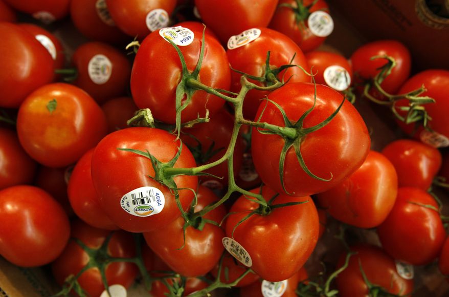FILE - In this March 23, 2011 file photo, tomatoes are seen in the produce section at a grocery store in Des Moines, Iowa. Scientists have cooked up a way to reintroduce a key ingredient into mass-produced tomatoes: taste. Researchers have figured out just the right spots on the genetic blueprint of tomatoes where flavor has been bred out of supermarket tomatoes for the past 40 or 50 years, according to a study in the journal Science. And using natural breeding methods, a little modernized with hand pollination by electric toothbrushes _ they are reinstalling five factors to add aroma and taste into the staple of salads. (AP Photo/Charlie Neibergall, File)