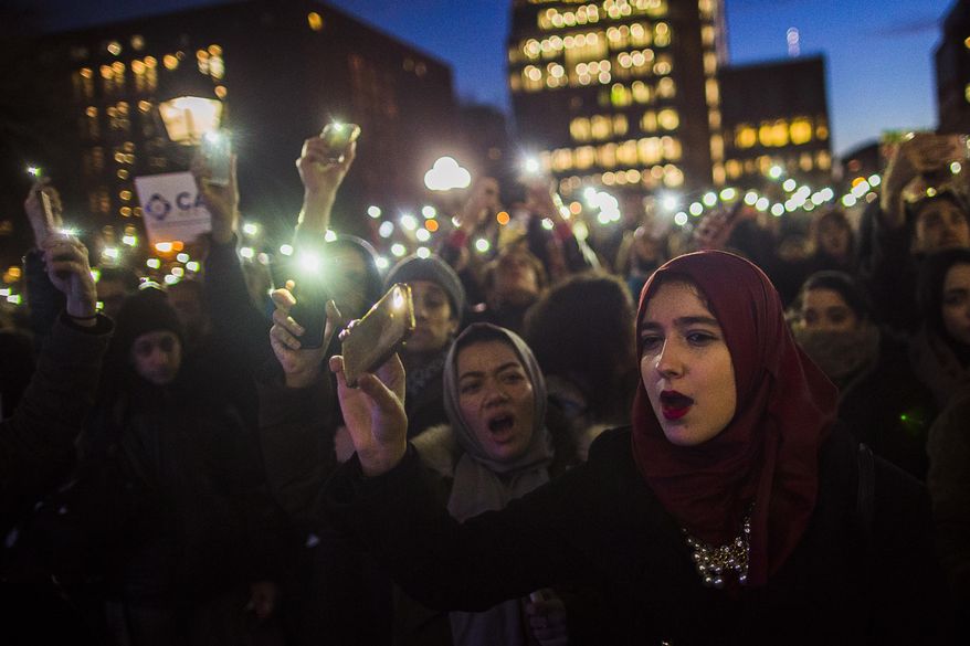 Muslim women shout slogans during a rally against President Donald Trump's order cracking down on immigrants living in the U.S. at Washington Square Park in New York, Wednesday, Jan. 25, 2017. (AP Photo/Andres Kudacki)