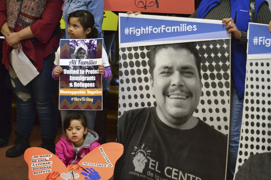 Jocelynn Lujan, 6, sitting below, and her sister, Jennifer, 8, above, attend a news conference in Albuquerque, N.M., Wednesday, Jan. 25, 2017, where activists denounced President Donald Trump's executive actions on immigration. Many U.S. Muslim and Latino advocates have been speaking out and preparing lawsuits against executive actions taken by President Donald Trump to build a Mexican border wall and strip funding for immigrant protecting sanctuary cities, as well as anticipated orders to restrict refugees. (AP Photo/Russell Contreras)