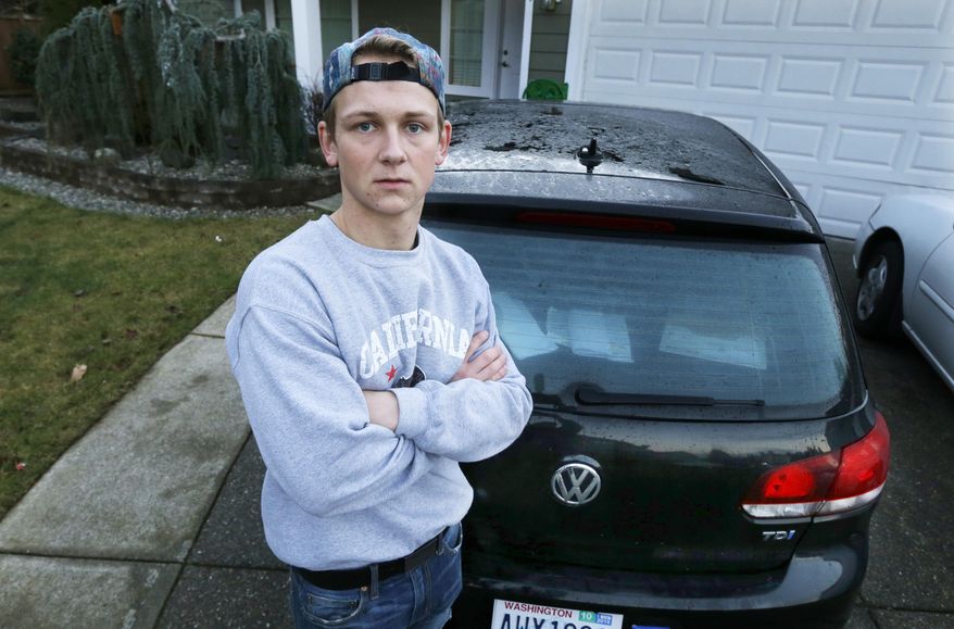 In this Tuesday, Jan. 24, 2017, photo, David Derkach poses for a photo with his Volkswagen Golf, at his home in Federal Way, Wash. Derkach has faced delays in getting Volkswagen to buy back his diesel-engine vehicle following VW's emissions-cheating scandal. (AP Photo/Ted S. Warren)