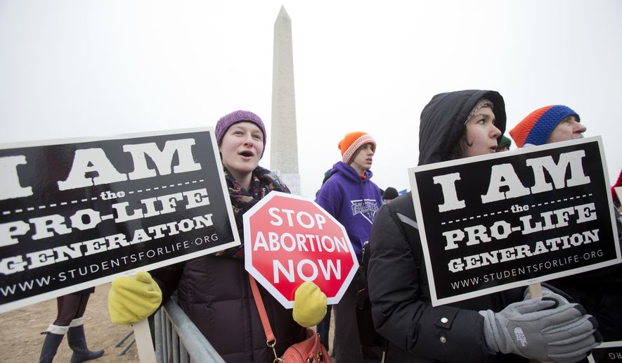In this Friday, Jan. 22, 2016, file photo, Michelle Doyle, left, joins the March for Life 2016 rally, commemorating the anniversary of 1973 &quot;Roe v. Wade&quot; U.S. Supreme Court decision legalizing abortion in Washington. The annual rally will be held Friday, Jan. 27, 2017, on the National Mall in the nations capital. (AP Photo/Manuel Balce Ceneta, File)