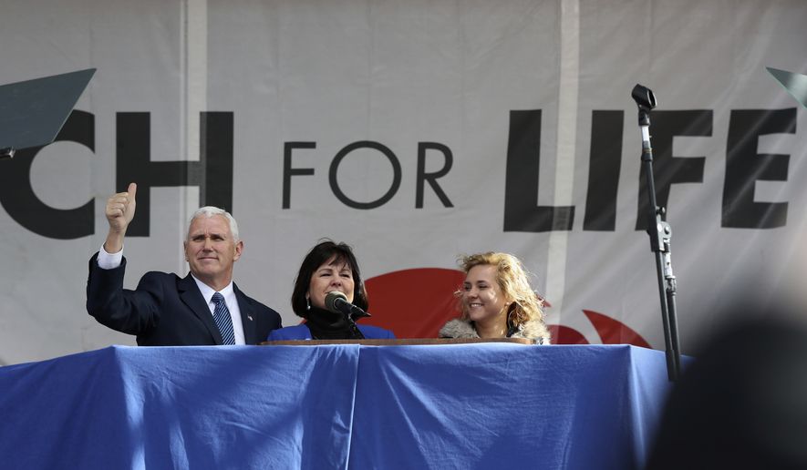 Vice President Mike Pence, with his wife Karen Pence, center, flashes a thumbs up at the March for Life on the National Mall in Washington, Friday, Jan. 27, 2017. (AP Photo/Manuel Balce Ceneta)