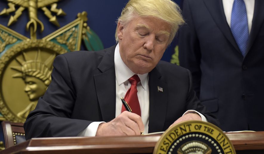 President Donald Trump signs an executive order on extreme vetting during an event at the Pentagon in Washington, Friday, Jan. 27, 2017. (AP Photo/Susan Walsh)