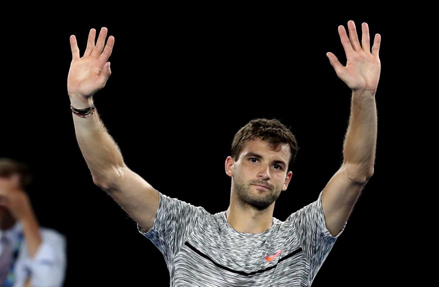 Bulgaria's Grigor Dimitrov waves after losing to Spain's Rafael Nadal in their semifinal at the Australian Open tennis championships in Melbourne, Australia, early Saturday, Jan. 28, 2017. (AP Photo/Aaron Favila)