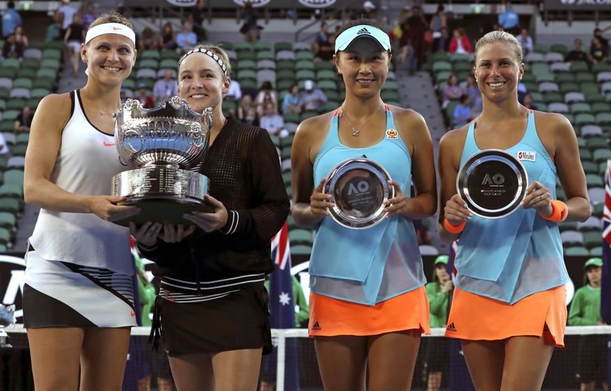 Lucie Safarova, left, of the Czech Republic and partner Bethanie Mattek-Sands, second from left, of the U.S. pose with their trophy after defeating Andrea Hlavackova , right, of the Czech Republic and Peng Shuai of China in the women&#39;s doubles final at the Australian Open tennis championships in Melbourne, Australia, Friday, Jan. 27, 2017.(AP Photo/Aaron Favila)