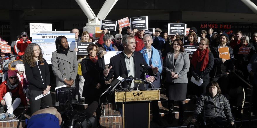 Sen. Jeff Merkley, D-Ore., speaks to a crowd during a rally in Portland, Ore., Friday, Jan. 27, 2017. Several hundred people gathered with Oregon congressional leaders in protest against Education Secretary nominee Betsy DeVos. (AP Photo/Don Ryan)