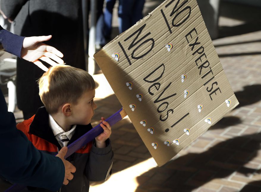 Asher Kockler, 3, carries a sign during a rally in Portland, Ore., Friday, Jan. 27, 2017. Several hundred supporters gathered with Oregon congressional leaders in protest against Education Secretary nominee Betsy DeVos. (AP Photo/Don Ryan)