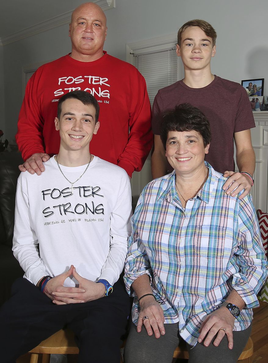 FOR RELEASE SATURDAY, JANUARY 28, 2017, AT 12:01 A.M. EST.- Brian, Matt, Zack and Kim Foster smile for a family portrait in their home in Wilson on Wednesday. (Sarah Louya/The Rocky Mount Telegram via AP)