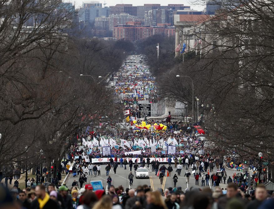 Anti-abortion activists march up Constitution Avenue en route to the Supreme Court in Washington, Friday, Jan. 27, 2017, during the 44th annual March For Life. (AP Photo/Carolyn Kaster)