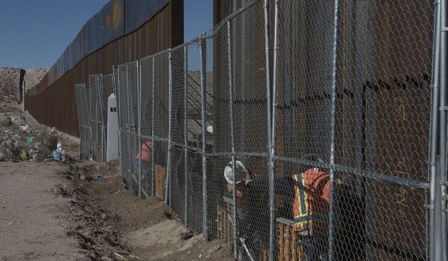Workers continue work raising a taller fence in the Mexico-US border separating the towns of Anapra, Mexico and Sunland Park, New Mexico, Wednesday, Jan. 25, 2017. U.S. President Donald Trump says his administration will be working in partnership in Mexico to improve safety and economic opportunity for both countries and will have &amp;quot;close coordination&amp;quot; with Mexico to address drug smuggling. It will set in motion the construction of his proposed border wall, a key promise from his 2016 campaign. (AP Photo/Christian Torres)