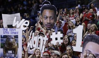 Fans in the Gonzaga student section hold up signs stating &amp;quot;We Want #1&amp;quot; signifying their desire for a #1 ranking for their team in the polls, before an NCAA college basketball game between Gonzaga and San Diego in Spokane, Wash., Thursday, Jan. 26, 2017. (AP Photo/Young Kwak)