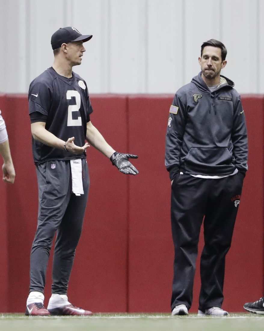 Atlanta Falcons quarterback Matt Ryan, left, stands on the field next to offensive coordinator Kyle Shanahan during a workout at the NFL football team's practice facility in Flowery Branch, Ga., Friday, Jan. 27, 2017. (AP Photo/David Goldman)