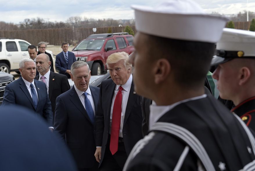 President Donald Trump, accompanied by Vice President Mike Pence, greets Defense Secretary James Mattis at the Pentagon, Friday, Jan. 27, 2017. (AP Photo/Susan Walsh)