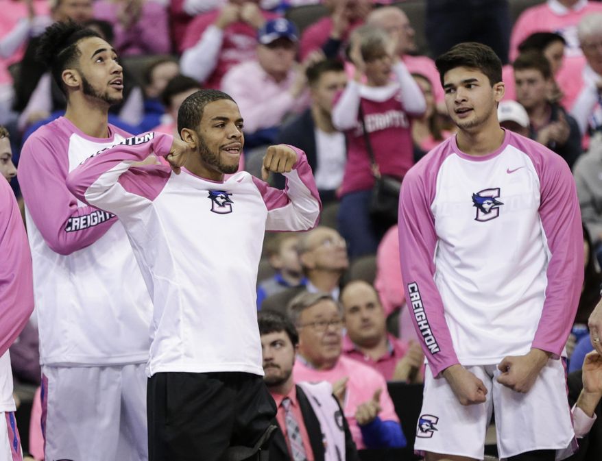 Creighton's Maurice Watson Jr., center, Ronnie Harrell Jr., left, and Kobe Paras, right, react to a point during the second half of an NCAA college basketball game against DePaul in Omaha, Neb., Saturday, Jan. 28, 2017. Creighton won 83-66. (AP Photo/Nati Harnik)