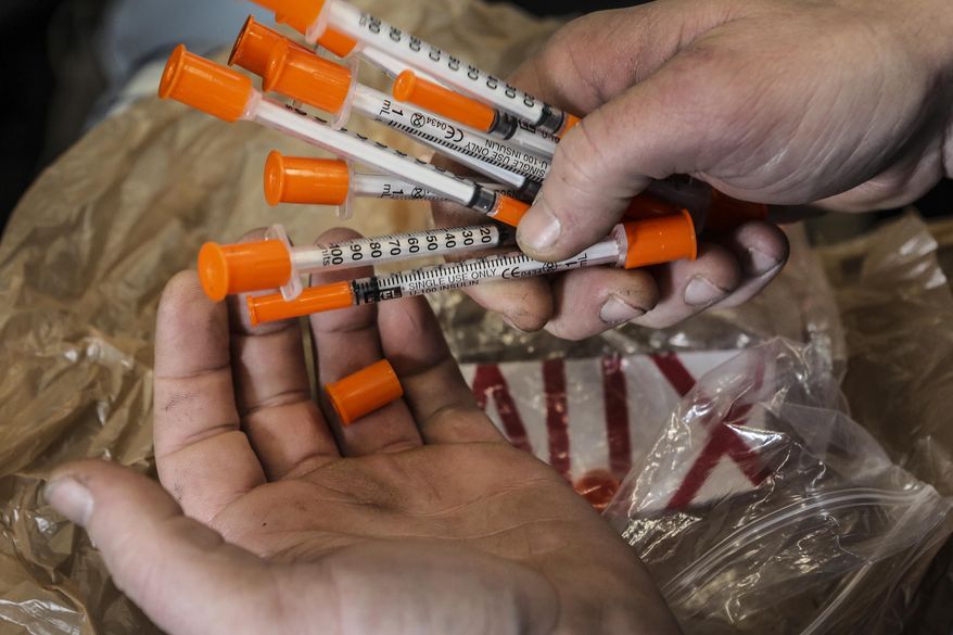 An intravenous drug user exchanges syringes at Franklin County Health Department in Franklin County, Ky. Since state lawmakers decided in March 2015 to allow needle exchanges in Kentucky, 21 have been established. (Michael Clevenger/The Courier-Journal via AP)