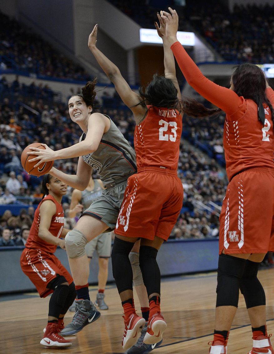 Connecticut&#39;s Natalie Butler looks to shoot around the defense of Houston&#39;s Angela Harris, left, Serithia Hawkins, center, and Jacqueline Blake, right, in the second half of an NCAA college basketball game, Saturday, Jan. 28, 2017, in Hartford, Conn. (AP Photo/Jessica Hill)