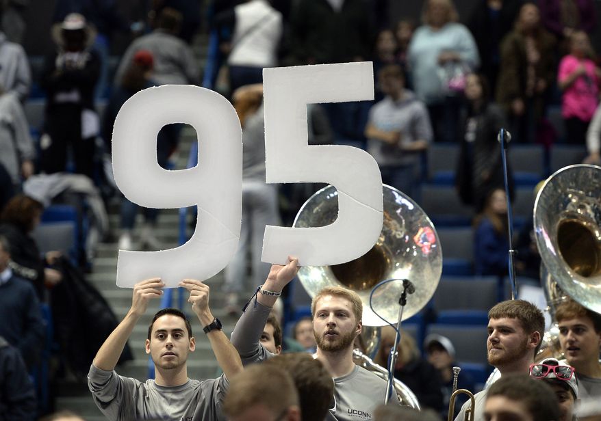 Members of the University of Connecticut band holds up the number 95 at the end of an NCAA college basketball game against Houston, Saturday, Jan. 28, 2017, in Hartford, Conn. UConn won it's 95th game in a row. (AP Photo/Jessica Hill)