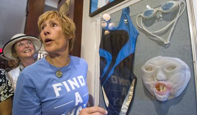 In this photo provided by the Florida Keys News Bureau, marathon swimmer Diana Nyad, right, addresses attendees at a dedication ceremony of a new exhibit at the Key West Art &amp;amp; Historical Society&#39;s Custom House Museum Friday, Jan. 27, 2017, in Key West, Fla. Nyad donated her swimsuit, goggles and a jellyfish mask she used in 2013 to complete an almost 111-mile swim from Cuba to Key West, becoming the first person to cross the Florida Straits without a shark cage. (Carol Tedesco/Florida Keys News Bureau via AP)