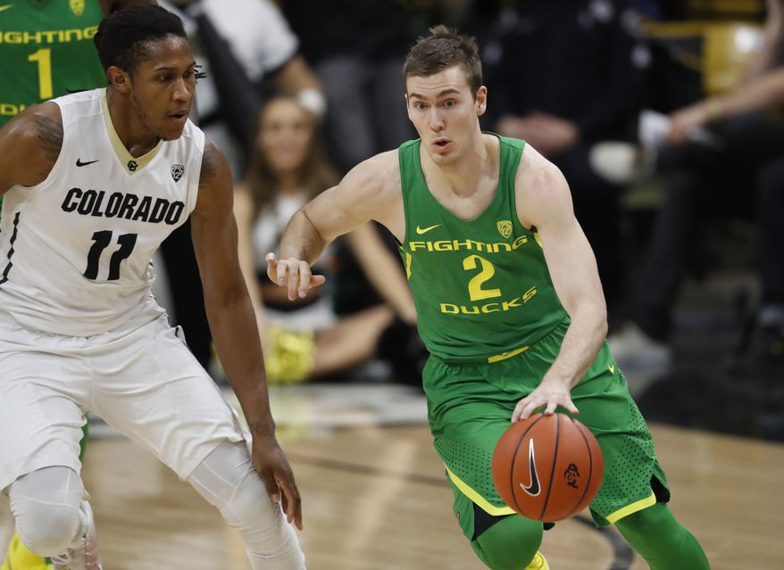 Oregon guard Casey Benson, right, drives past Colorado guard Xavier Johnson after picking up the ball in the first half of an NCAA college basketball game Saturday, Jan. 28, 2017, in Boulder, Colo. (AP Photo/David Zalubowski)